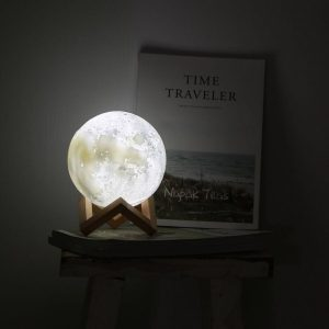 Portable Moonlight 12cm – 3D Moon Lamp with wooden stand glowing on a shelf